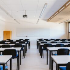 Empty classroom in education university White classroom in education university with blue chairs