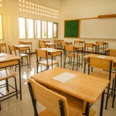 School classroom with test exam paper on desks chair wood, and b School empty classroom with test sheet or exams paper on desks chair wood and greenboard at high school thailand, education test concept